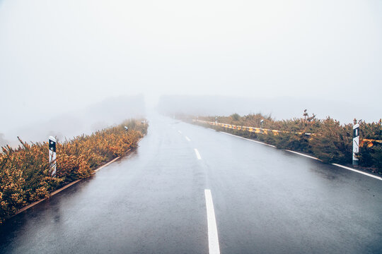 Fog covers the road on a rainy day creating low visibility conditions in Ponta do Sol, Madeira, Portugal
