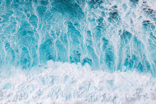 Abstract aerial view of blue waves showing patterns and textures over water in Ponta do Pargo, Madeira, Portugal