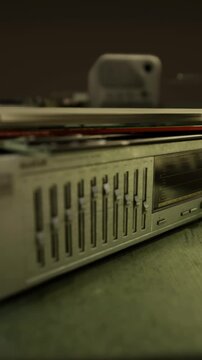 Closeup of old fashioned stereo system showing equalizer and knobs, High fidelity stereo receiver featuring tactile controls and warm studio tone ambiance