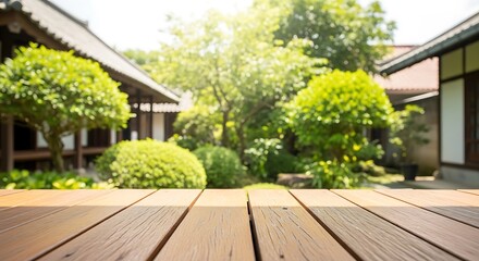 Obraz premium A serene Japanese garden with a wooden table in the foreground and traditional buildings in the background.