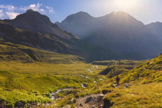 A trekker walks in the middle of Vallee Etroite in front of Roche Bernaude, Cote d&acirc;&euro;&trade;Azur, Haute Alps, Vallee Etroite, France