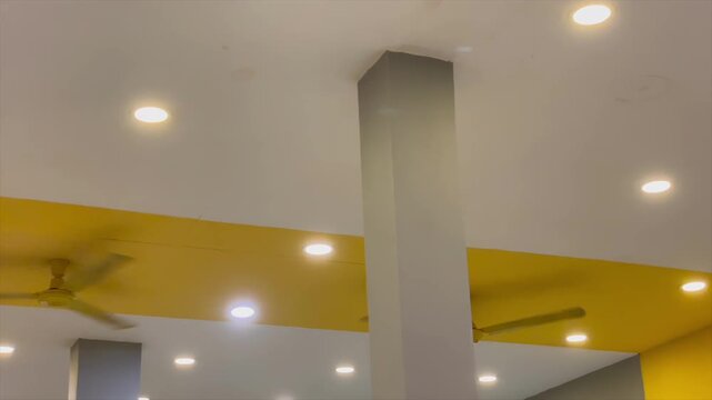 Modern ceiling interior design with recessed downlight lamps and yellow accent paint