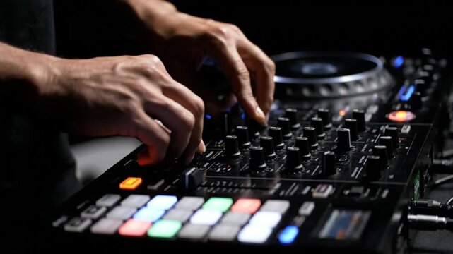 DJ's hands expertly mixing tracks on a professional DJ controller in a dark nightclub environment from a close-up viewpoint