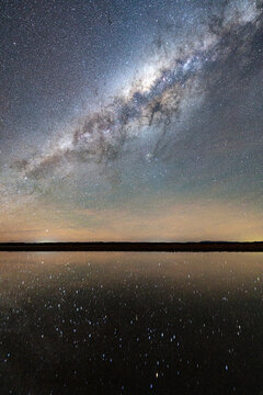 Starry night sky mirrored in a saline pool, Ojos del Mar, Tolar Grande, Argentina