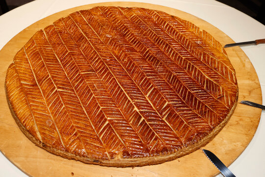 Galette des Rois (French King Cake) with Feve and Crown usually shared on the Epiphany to celebrate the arrival of the Three Wise men in Bethlehem.