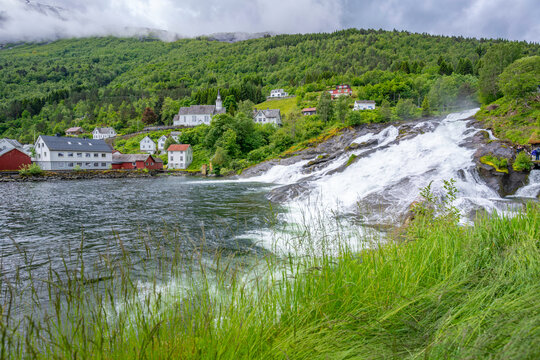 View of Sunnylven church and Hellesylt waterfall in Hellesylt, Sunnylvsfjorden, Stranda Municipality, Norway, Scandinavia, Europe