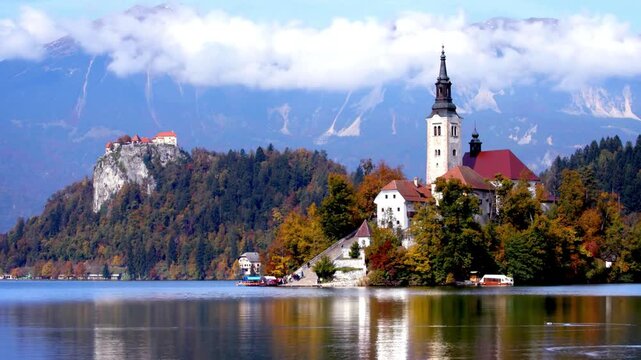 Breathtaking timelapse shot of lake bled island with pilgrimage church of the assumption of maria on a sunny summer day. European travel guides, historical documentaries, and peaceful nature