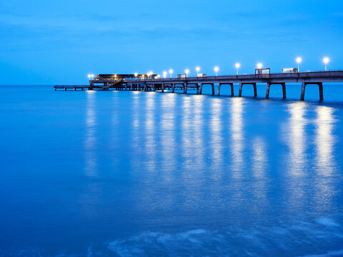 Evening light reflects on the water at the pier in Deal Kent during dusk hours