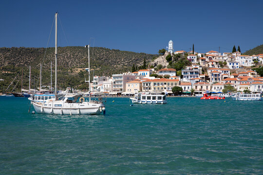 View of Poros town and clock tower from Galatas, Poros, Saronic islands, Greek Islands, Greece, Europe