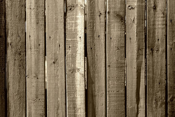An old wooden fence made of faded boards
