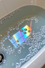 Fototapeta premium A bathtub filled with water reflecting a colorful rainbow pattern, surrounded by scattered bubbles floating on the surface.