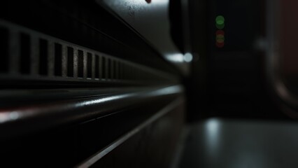 Shadows dance along the polished surfaces of an antique train interior as dim lights flicker in the backdrop. The ambiance evokes nostalgia and a sense of adventure.