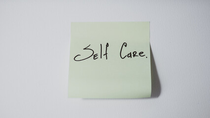 Self Care Reminder on Sticky Note on White Background