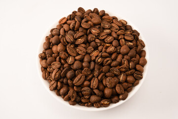 Fototapeta premium Coffee beans on a white background. Top view. Coffee beans texture.