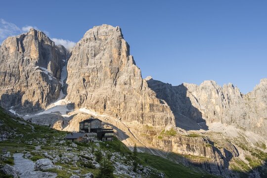 Sunrise, Rifugio Maria e Alberto ai Brentei, Crozzon di Brenta and Cima Tosa peaks in the back, Brenta Mountains, Brenta-Adamello Natural Park, Trentino, Italy