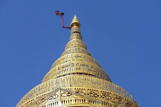 Umbrella over the Buddha statue in Wat Intharawihan, a ceremonial, often multi-level symbol of protection and sanctuary, Wat Intharawihan, the temple was built at the beginning of the Ayutthaya period, Bangkok, Thailand