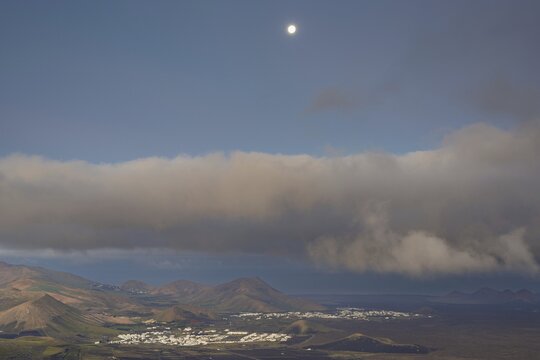 Panorama at sunrise from the Montana de Guardilama to the wine-growing area La Geria, behind it the villages Uga and Yaiza, Lanzarote, Canary Islands, Spain