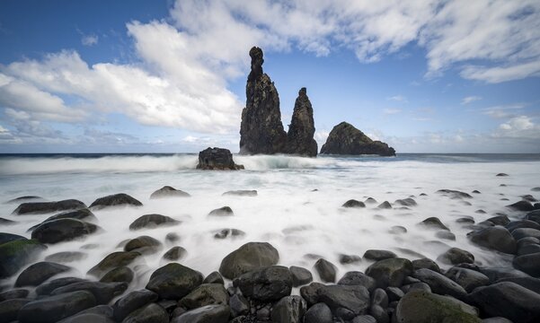 Long exposure, beach with volcanic rock, rock formation Ilheus da Rib and Ilh&eacute;u da Ruama in the sea, Praia da Ribeira da Janela, Madeira, Portugal