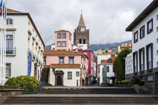 Small square in the old town with colourful houses and chapel Capela de Santo Antonio de Mouraria, tower of the church S&eacute; do Funchal in the back, Funchal, Madeira, Portugal