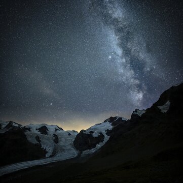 Starry sky with Milky Way over Morteratsch Glacier in Bernina Group, St Moritz, Engadine, Grisons, Switzerland