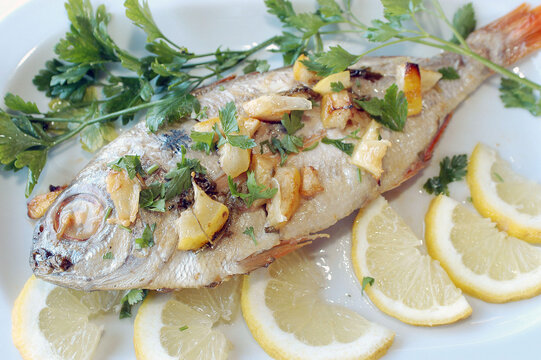 Pagello al forno con patate is a typical food from Liguria region in Italy.