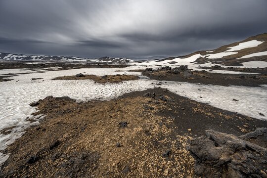Snow-covered volcanic landscape with tuff and petrified lava, crater of Askja volcano, Icelandic highlands, Iceland