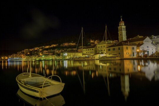 Church of St. Jerome of Stridon with rowing boat and sailboats at night, Puči&scaron;ća, Split-Dalmatia County, Croatia