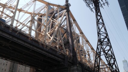 New York City Manhattan Midtown, Queensboro bridge architecture in United States. Urban transport bridge over East River. View from below, under metallic bridge in East Side near Roosevelt island.