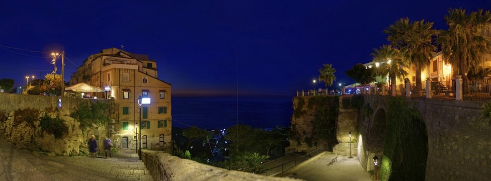 Sea view panorama with the medieval old town of Tropeain the evening twilight, Belvedere Piazza del Cannone, Tropea, Calabria, Vibo Valentia, Southern Italy, Italy