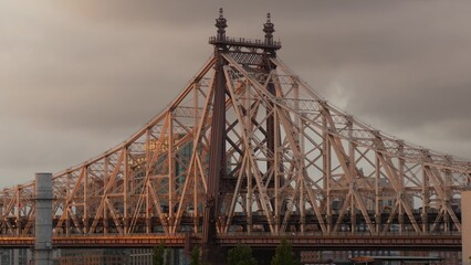 Obraz premium New York City Manhattan Midtown skyline from Queens, Queensboro bridge architecture, United States. Cityscape from rooftop, Long Island Hunters Point. Urban sunset over transport bridge. Rainy clouds.