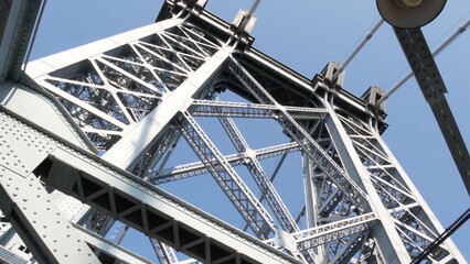 Williamsburg Bridge from Manhattan to Brooklyn, New York City, USA. Architecture of United States, tourist landmark. Metallic cable-stayed bridge. Cables and sky from pedestrian path. Low angle.