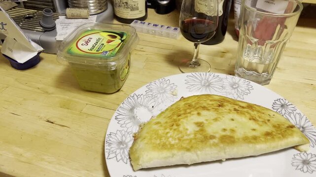 homemade enchiladas with a glass of red wine