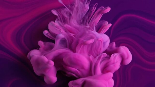 A mesmerizing display of vibrant magenta ink gracefully diffuses and swirls within a deep purple liquid, creating an ethereal and abstract motion background. The organic plumes of color expand and ble