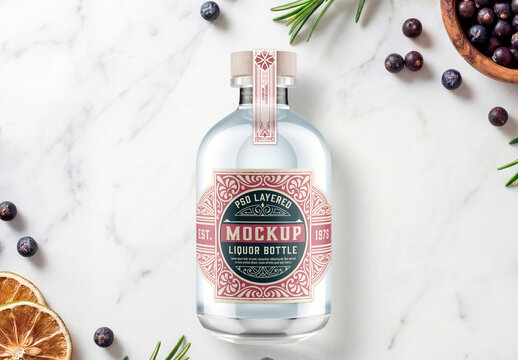 Clear Glass Spirit Bottle on Marble with Botanicals