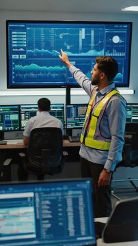 IT Specialist Monitoring Network Systems in Modern Data Center, Analyzing Performance Data with Focused Attention.