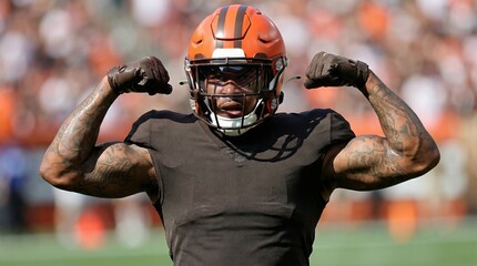 American football player celebrates victory stadium field action shot energetic atmosphere dynamic angle sport spirit