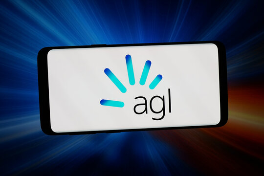 Stuttgart, Germany - 02-14-2026: In this photo illustration, the logo of Australian utility company AGL Energy Ltd. is displayed on a smartphone in front of abstract background on computer screen.