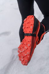 bright orange trail shoes with metal spikes