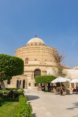 Historic church St. George in Coptic Cairo with domed sanctuary and urban surrounding buildings