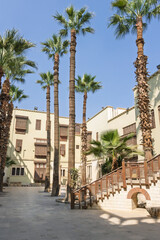 Curved wooden staircase and courtyard architecture at the Coptic Museum in Cairo, historic museum exterior