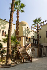 Curved wooden staircase and courtyard architecture at the Coptic Museum in Cairo, historic museum exterior
