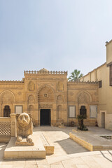 Entrance of Coptic Museum in Cairo showing lion sculpture and ornate carved architecture
