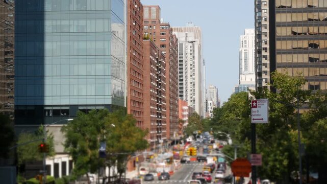 Manhattan Midtown straight street New York City, United States. Lenox Hill district York avenue, Upper East Side buildings. Urban road car traffic from Queensboro Bridge. Crossroad intersections.