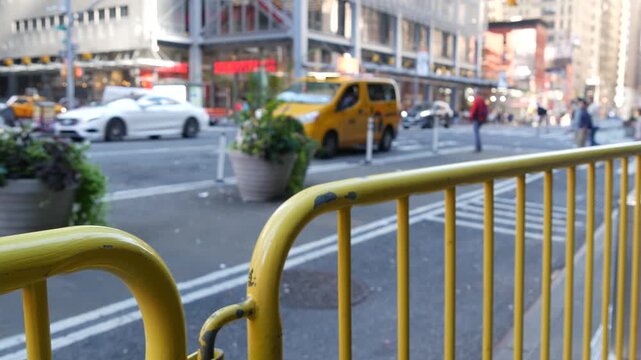 Manhattan Midtown street New York City, United States of America. Port authority bus terminal. Defocused car traffic on urban road, 8th avenue in Hells Kitchen. People pedestrian, yellow taxi cab.