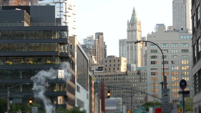 New York City Woolworth building 1913, skyscraper on Broadway in Downtown Financial District, Lower Manhattan, United States of America. Historic architecture, cooper roof, Varick street, hot steam.