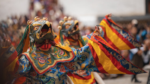 Thimphu, Bhutan - 28 September 2025: View of dancers in vibrant masks and costumes perform a traditional dance at Tashichho Dzong, a spectacle of color and culture.