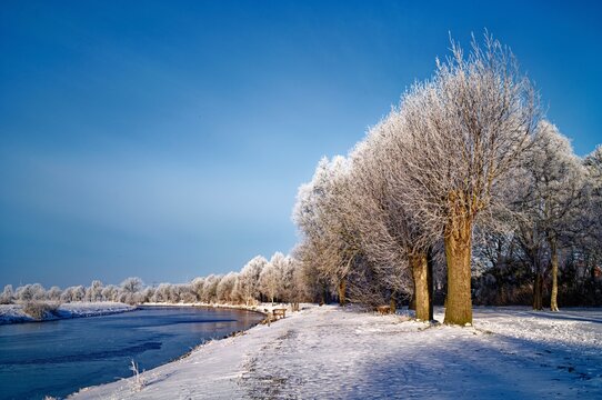 Snowy winter landscape by an Ems side canal, East Frisia, Lower Saxony, Germany
