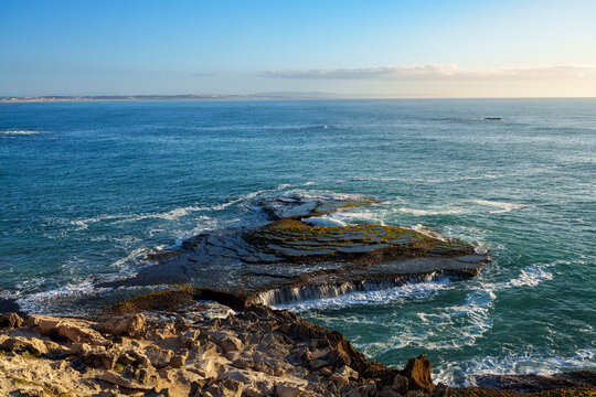 Dramatic rocky coastline near Waenhuiskrans Cave, Arniston Rock ledges meet ocean waves in pristine Overberg seascape, Western Cape, South Africa. Ideal for nature, travel, and adventure visuals.