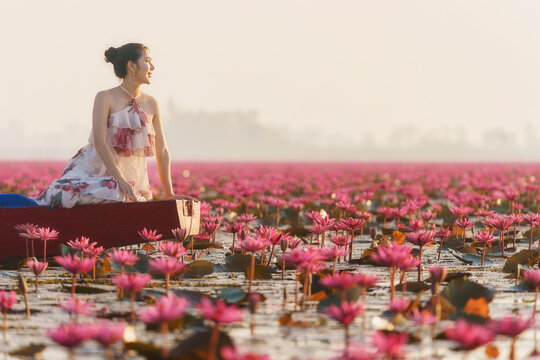 Side view of a young woman sitting in a boat looking at the view, Red Lotus Sea (Talay Bua Daeng), Udon Thani, Northeast Thailand, Thailand