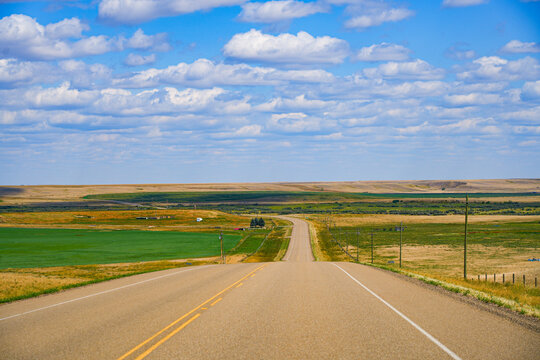 Straight road in the flatlands of the Canadian Prairie in Alberta, Canada